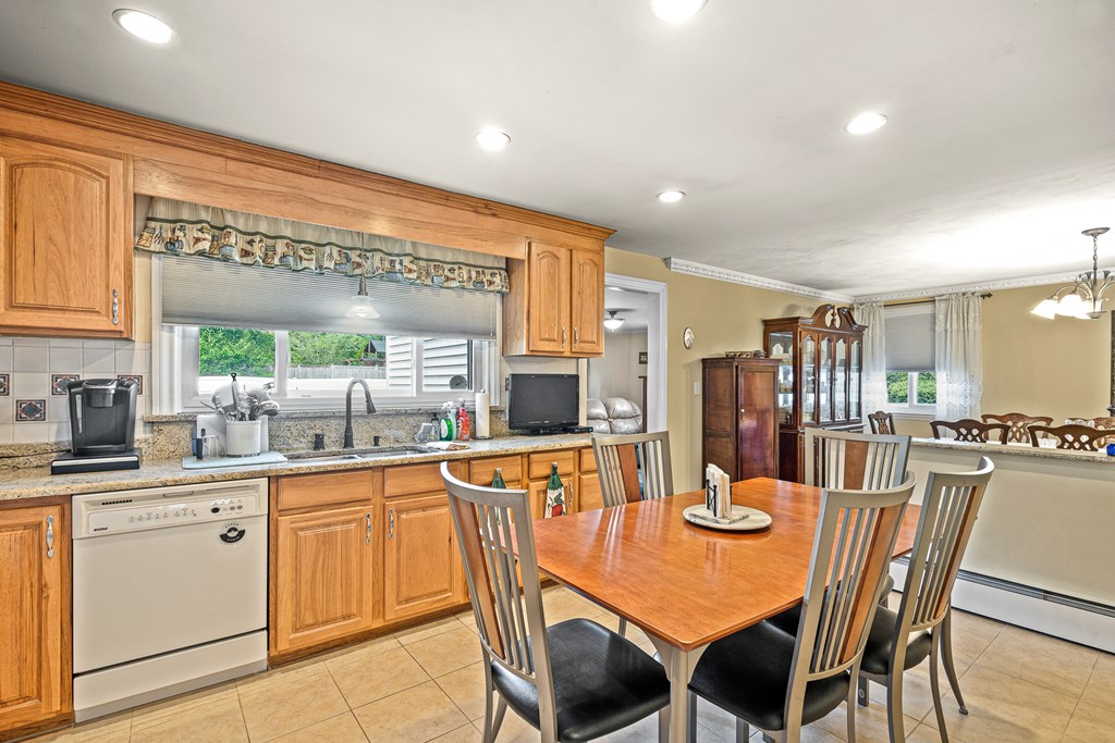 23 Webster Road Lexington, MA 02421 - Photo 3 of 32 a dining hall with stainless steel appliances a dining table chairs and granite counter tops