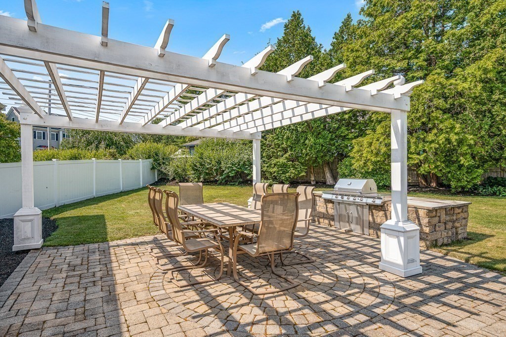 23 Webster Road Lexington, MA 02421 - Photo 31 of 32 a view of a patio with table and chairs potted plants with wooden floor and fence