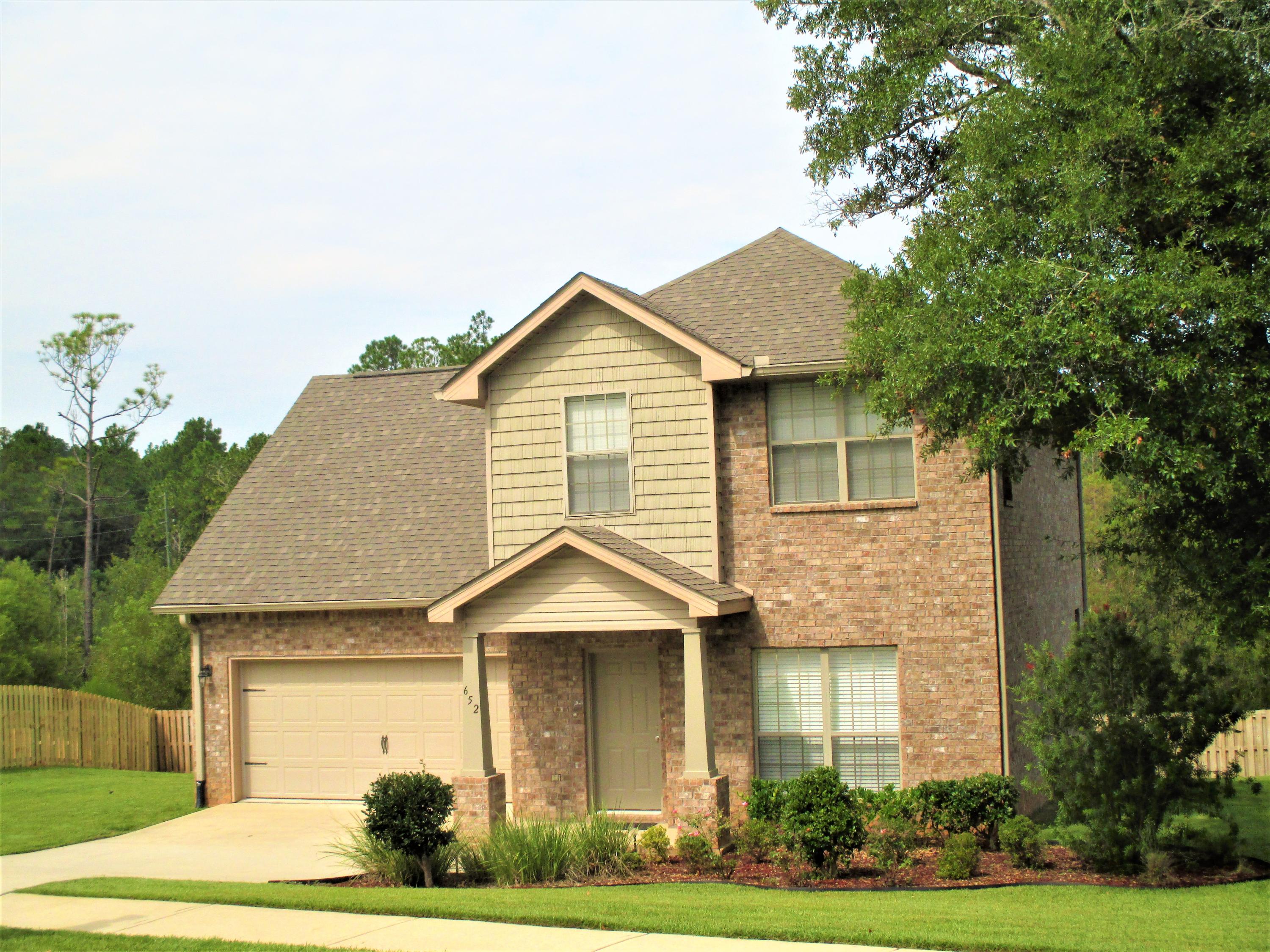 652 Red Fern Road Crestview, FL 32536 - Photo 1 of 32 a front view of a house with a yard