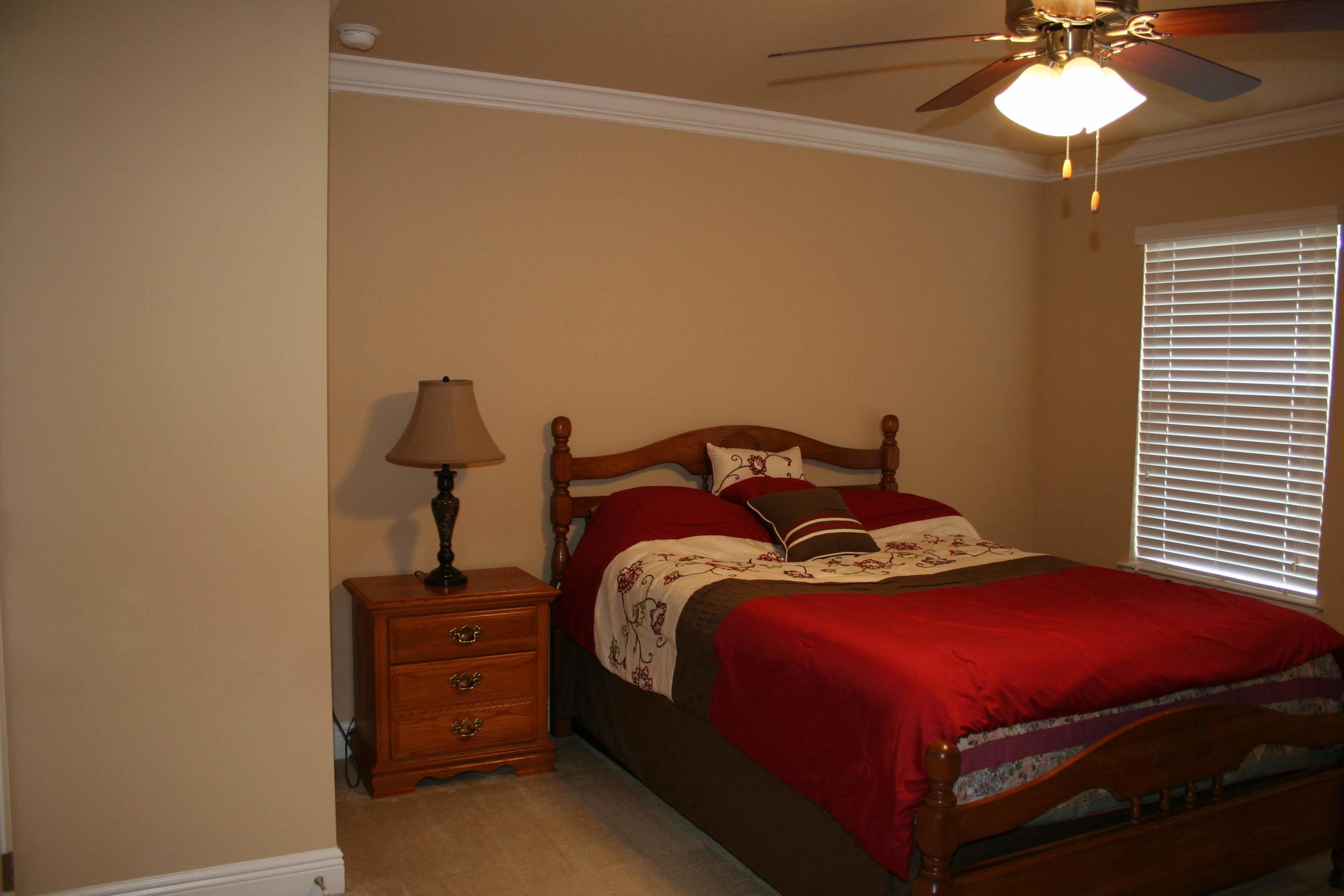 652 Red Fern Road Crestview, FL 32536 - Photo 15 of 32 a bedroom with a bed and a chandelier
