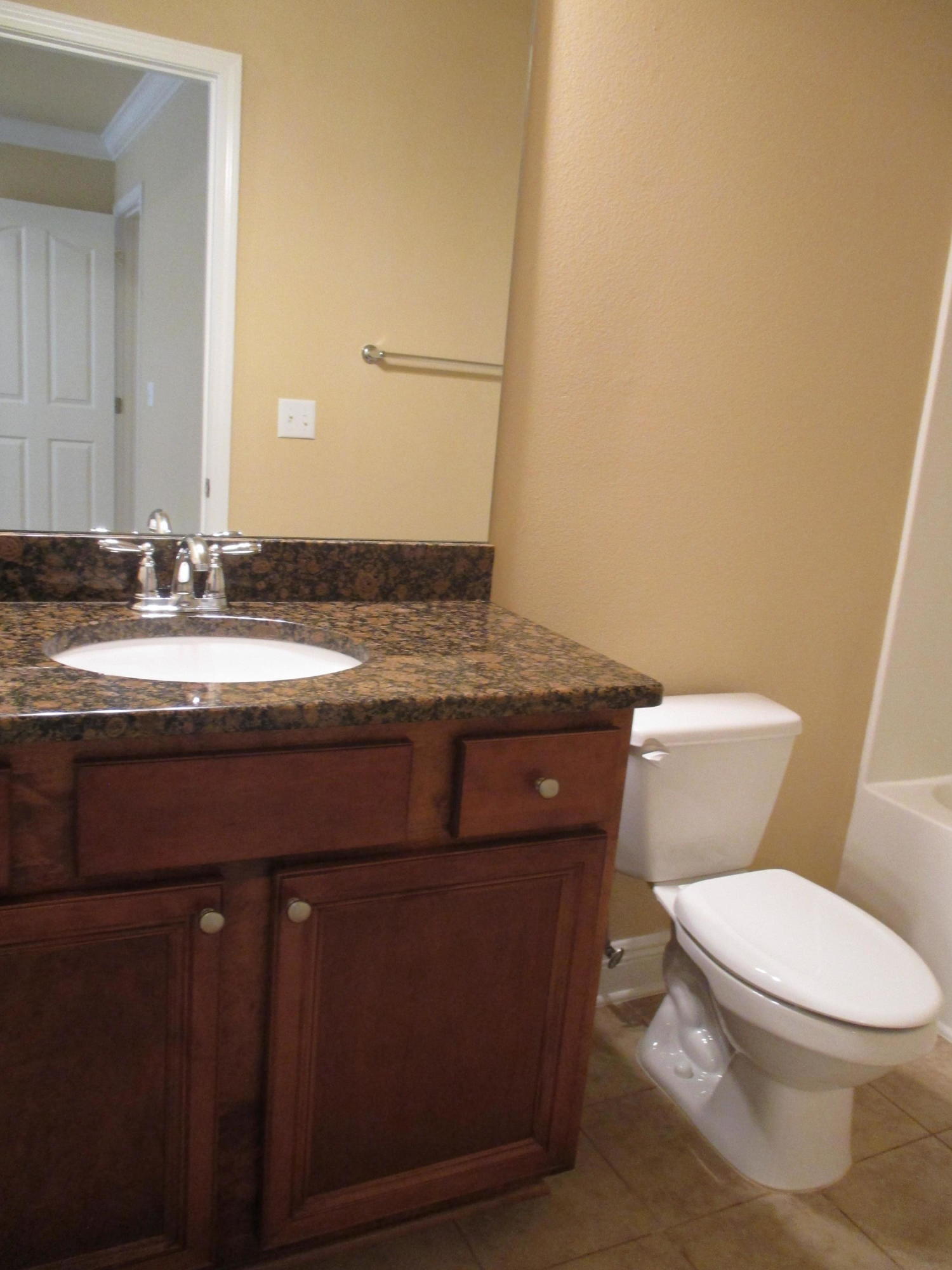 652 Red Fern Road Crestview, FL 32536 - Photo 17 of 32 a bathroom with a granite countertop toilet sink and mirror