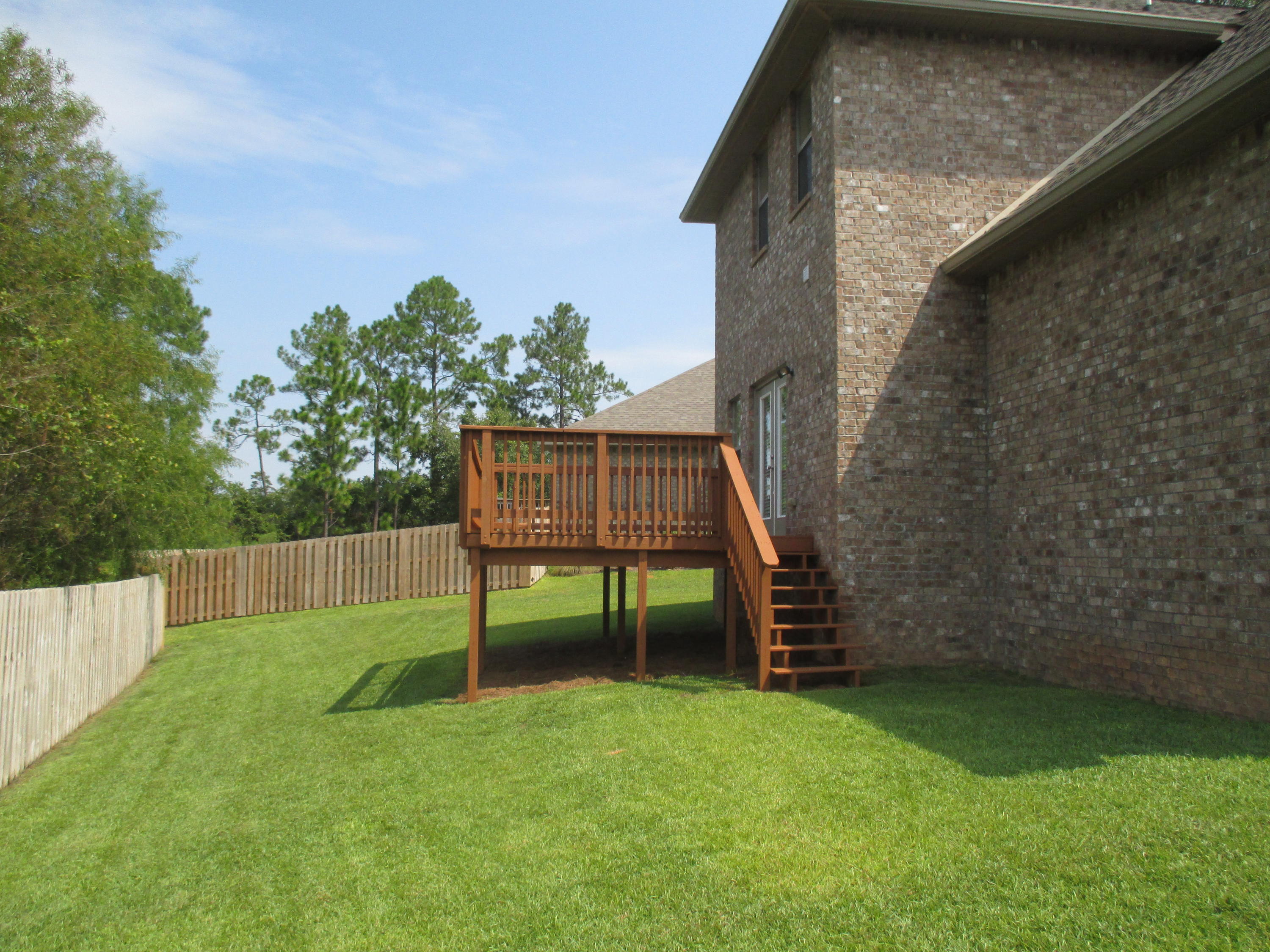 652 Red Fern Road Crestview, FL 32536 - Photo 27 of 32 a view of a chair and table in the backyard