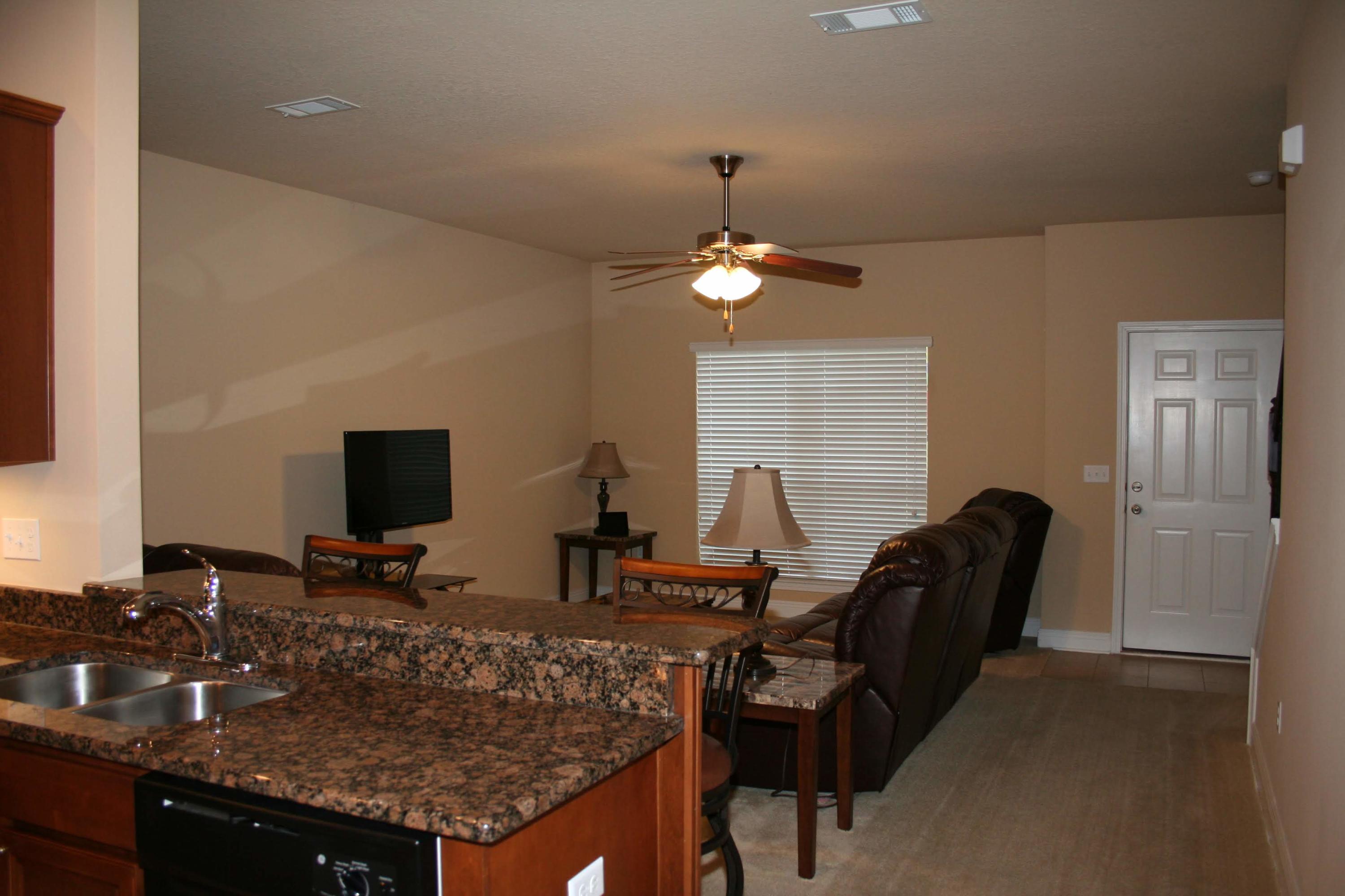 652 Red Fern Road Crestview, FL 32536 - Photo 8 of 32 a view of a workspace with furniture and a flat screen tv