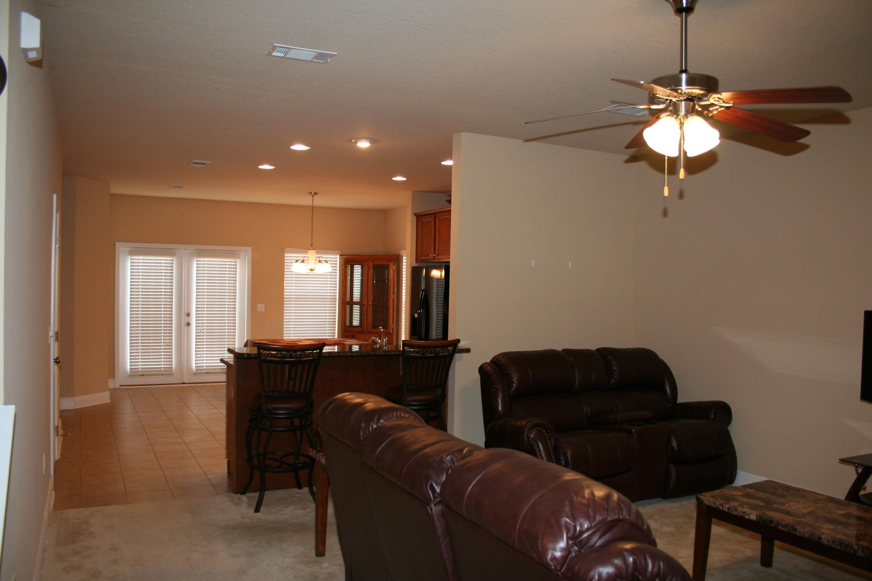 652 Red Fern Road Crestview, FL 32536 - Photo 10 of 32 a living room with furniture and a chandelier
