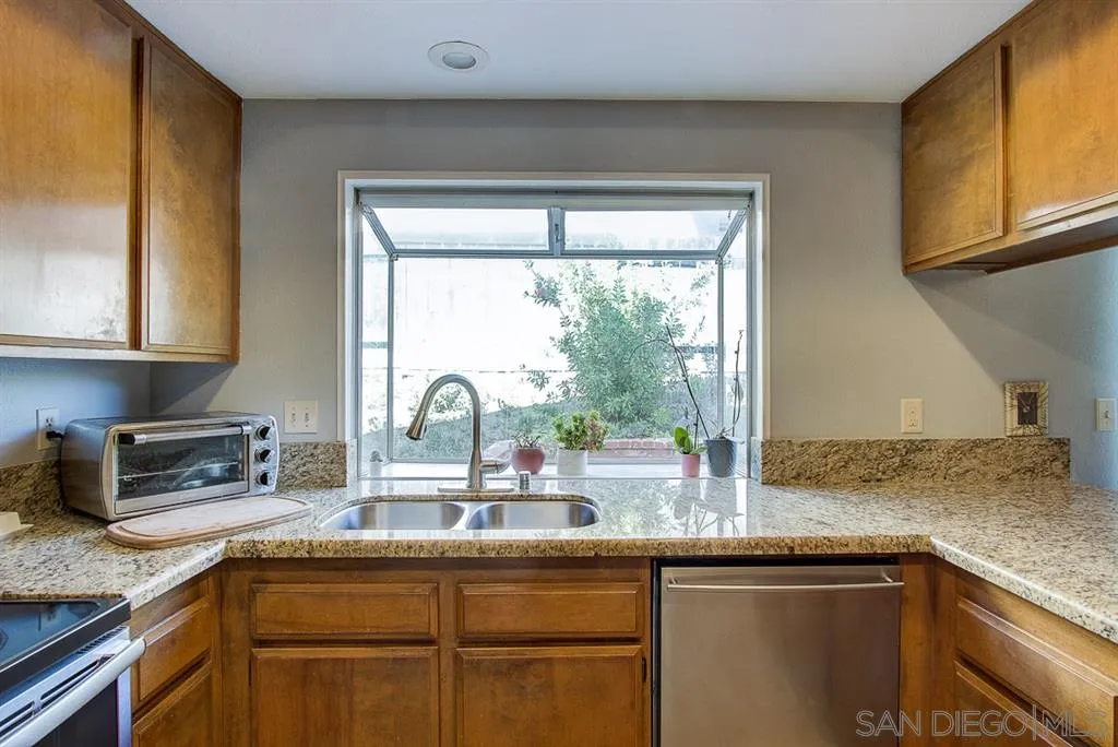 3577 Ridge Road Oceanside, CA 92056 - Photo 7 of 22 a kitchen with granite countertop a sink and a window