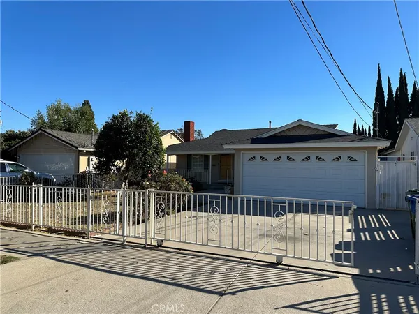 a view of a house with a wooden fence