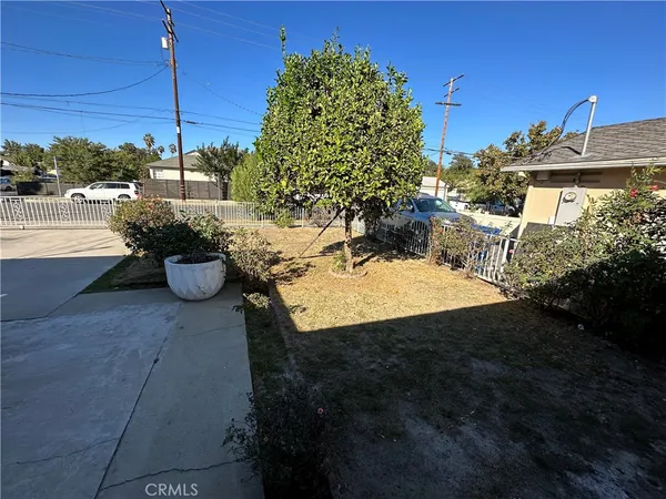 a view of a patio with dining table and chairs potted plants