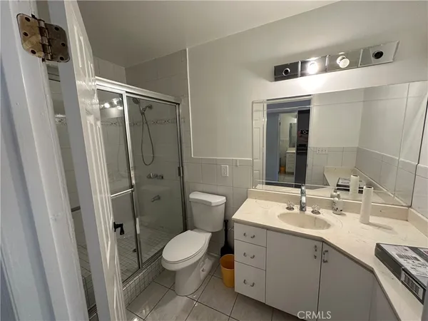 a bathroom with a double vanity sink toilet and shower