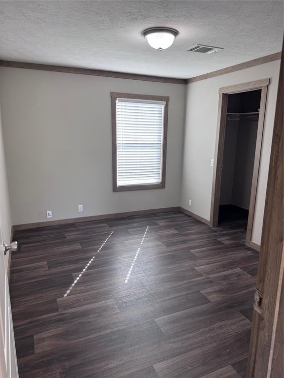 7268 Brangus Road Anna, TX 75409 - Photo 20 of 21 Room featuring wood-finish flooring, a neutral wall palette, and contrasting trim