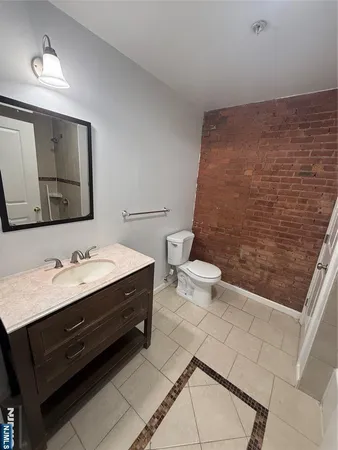 a bathroom with a sink a toilet and mirror