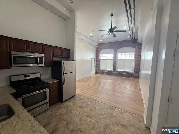 a view of a kitchen with a stove a microwave and a refrigerator