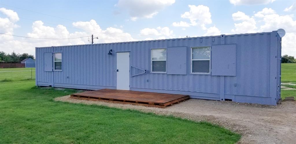 a view of a backyard with wooden fence