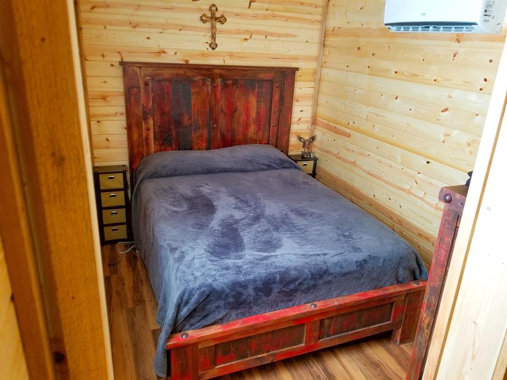 350 Summerfield Court Springtown, TX 76082 - Photo 11 of 20 a bedroom with a bed and wooden floor