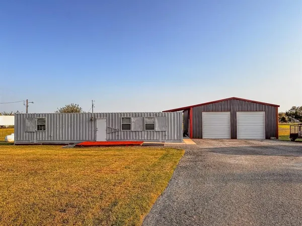 a view of a house with a backyard