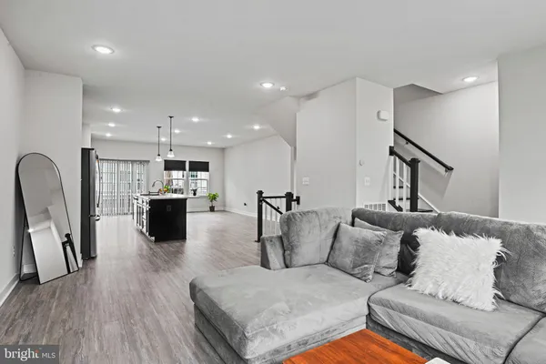 a living room with furniture kitchen view and a couch