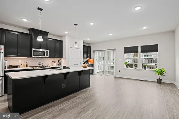 a large kitchen with stainless steel appliances kitchen island a large island in the center
