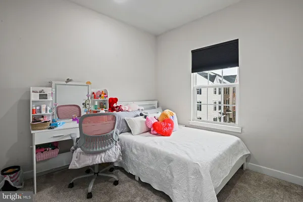 a bedroom with a bed and a table in it