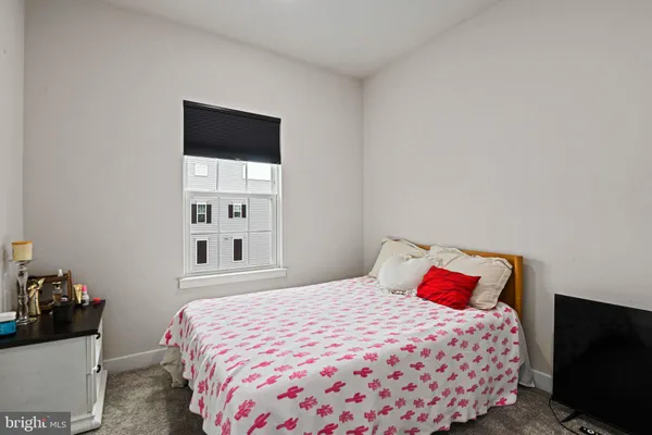 a bedroom with a bed and a flat tv screen