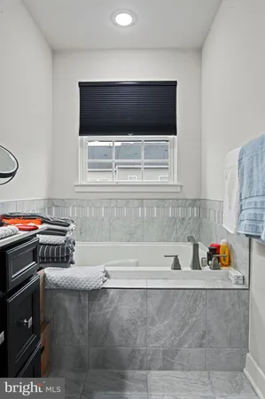 a bathroom with a sink vanity and a mirror
