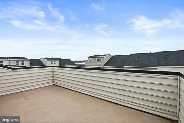 a view of a roof deck with table and chairs and wooden floor