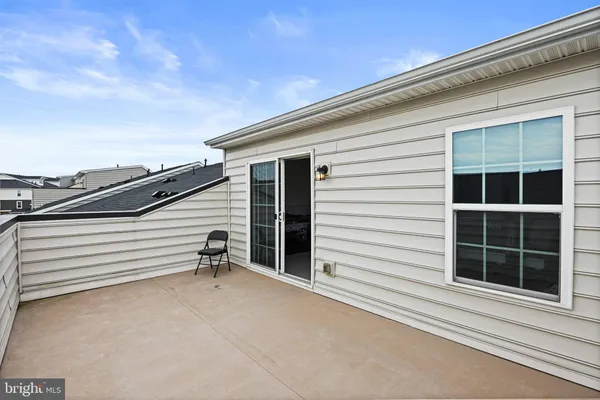 a view of a chair and table in the balcony