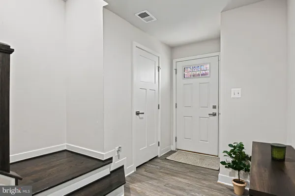 a view of an empty room with wooden floor
