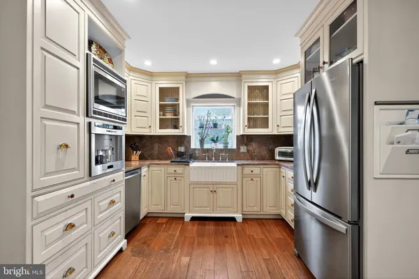 a kitchen with stainless steel appliances a refrigerator sink and cabinets