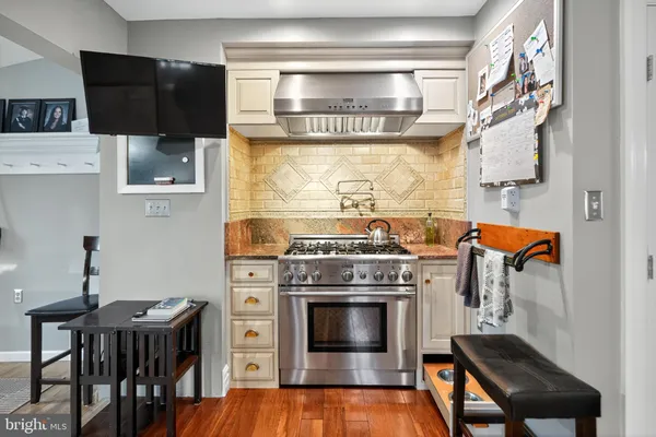a stove top oven sitting inside of a kitchen