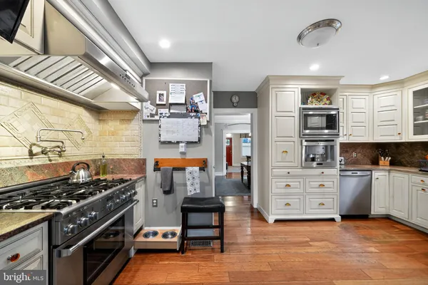 a kitchen with stainless steel appliances granite countertop a stove and a refrigerator