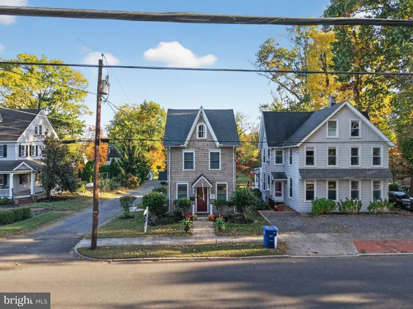 a front view of a house with a street