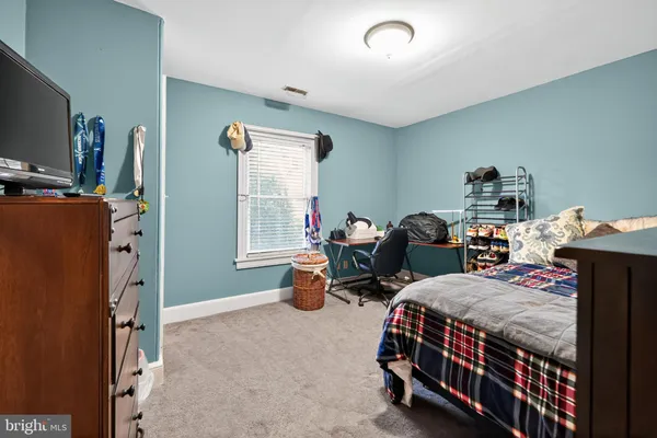 a bed room with bed and a tv