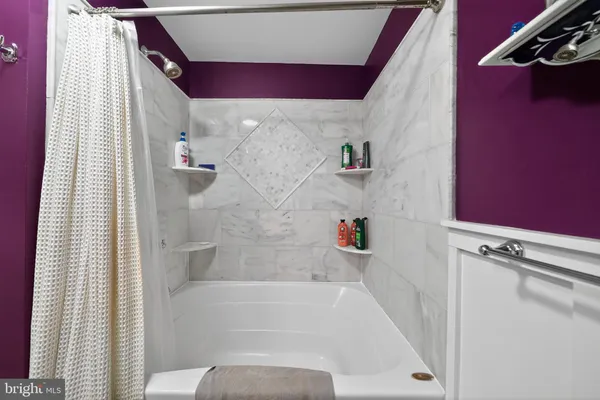 a bathroom with a bathtub and shower