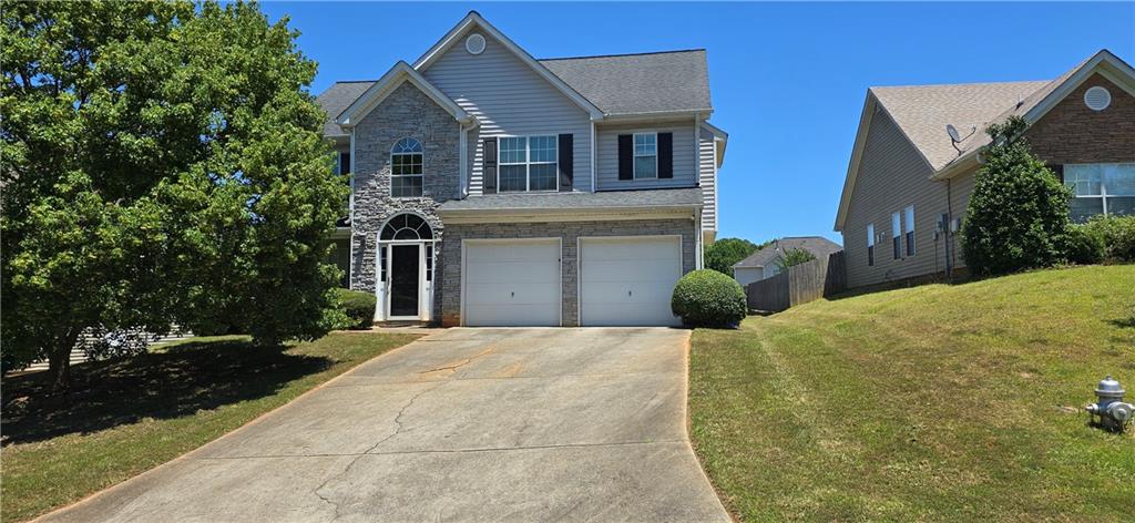 5759 Colonnade Drive Rex, GA 30273 - Photo 1 of 1 a front view of a house with a yard and garage