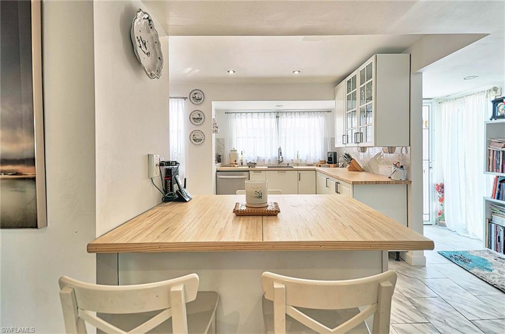 14 Watercolor Way, Unit 14 Naples, FL 34113 - Photo 11 of 28 a view of a dining room with furniture and wooden floor