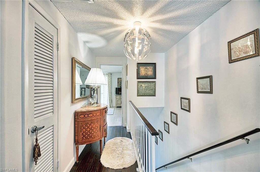 14 Watercolor Way, Unit 14 Naples, FL 34113 - Photo 21 of 28 a view of a livingroom with furniture a chandelier wooden floor and windows