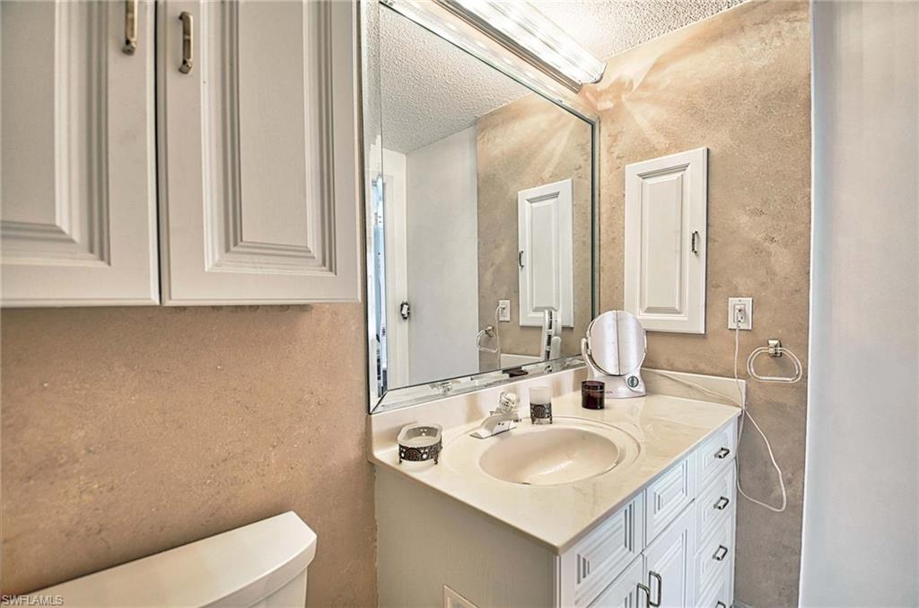 14 Watercolor Way, Unit 14 Naples, FL 34113 - Photo 22 of 28 a bathroom with a sink and a toilet
