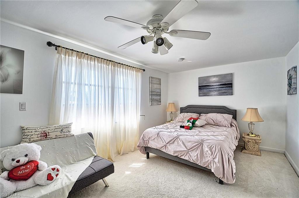 14 Watercolor Way, Unit 14 Naples, FL 34113 - Photo 23 of 28 a bedroom with a bed and a couch