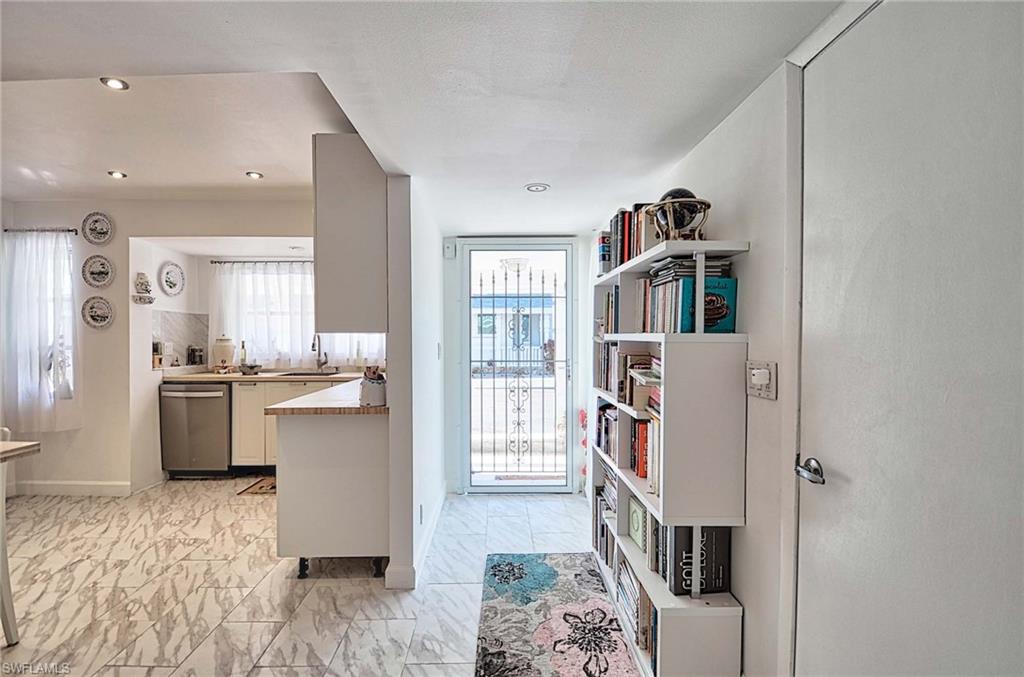 14 Watercolor Way, Unit 14 Naples, FL 34113 - Photo 4 of 28 a living room with furniture and a book shelf