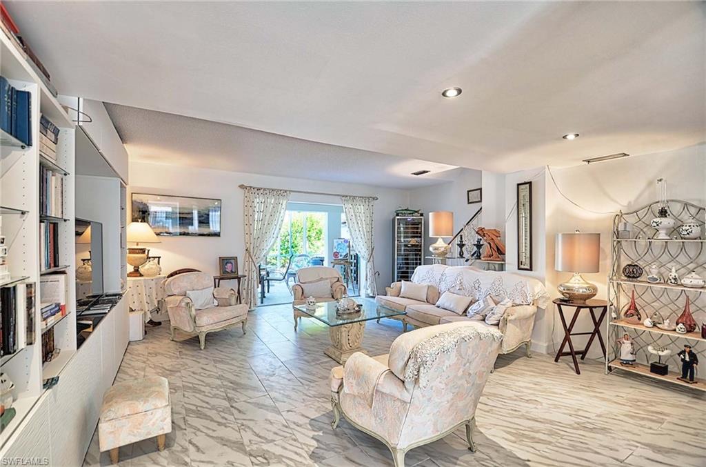 14 Watercolor Way, Unit 14 Naples, FL 34113 - Photo 5 of 28 a living room with furniture or couch and a wooden floor
