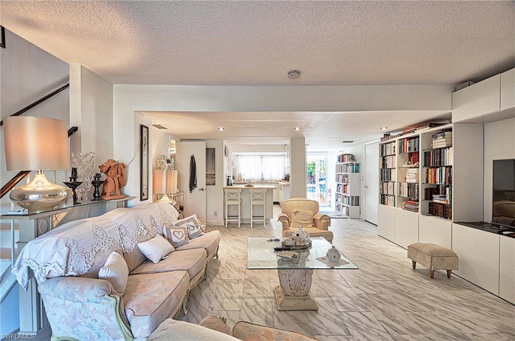 14 Watercolor Way, Unit 14 Naples, FL 34113 - Photo 7 of 28 a living room with furniture and wooden floor