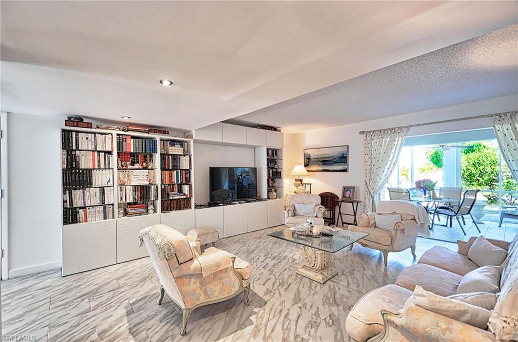 14 Watercolor Way, Unit 14 Naples, FL 34113 - Photo 8 of 28 a living room with furniture fireplace and a large window