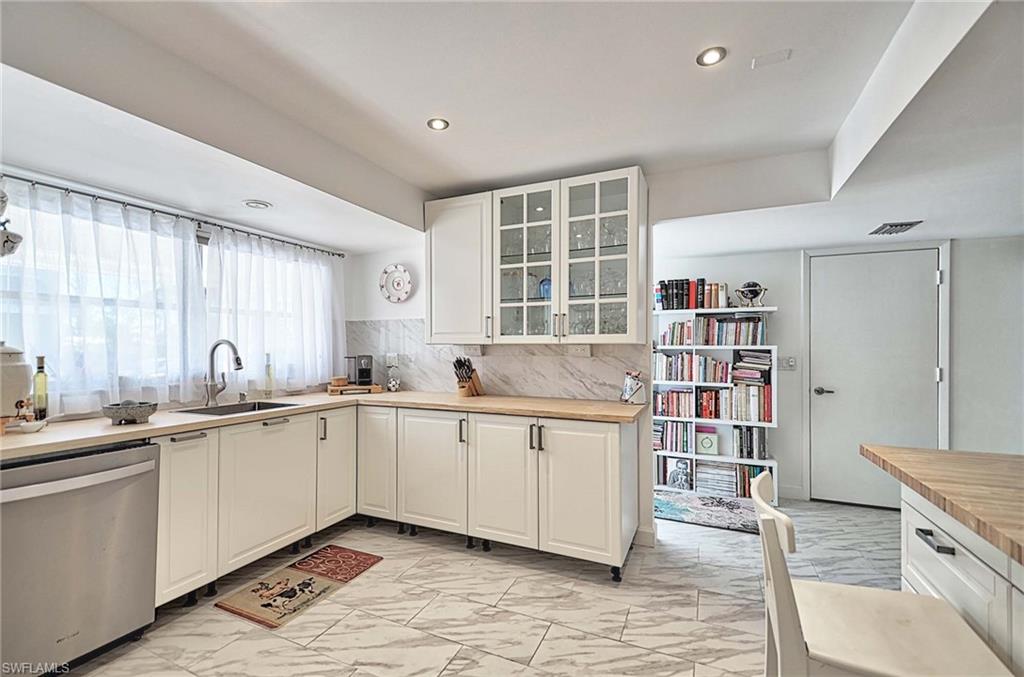 14 Watercolor Way, Unit 14 Naples, FL 34113 - Photo 9 of 28 a open kitchen with stainless steel appliances granite countertop a sink and cabinets