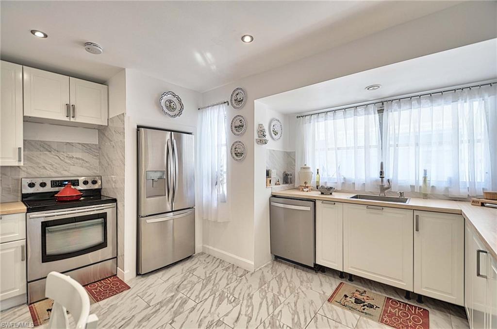 14 Watercolor Way, Unit 14 Naples, FL 34113 - Photo 10 of 28 a kitchen with stainless steel appliances granite countertop a refrigerator and a sink
