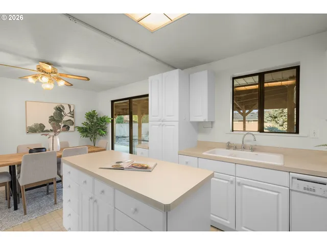a kitchen with a sink cabinets and a window