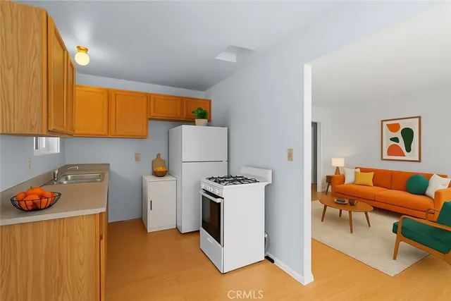 a workspace with furniture and a refrigerator