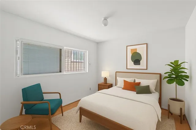 a bedroom with a bed and painting on the wall