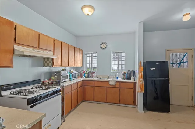 a kitchen with a sink stove and refrigerator