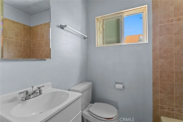 a bathroom with a sink mirror and toilet
