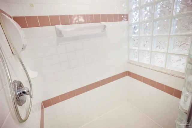 a bathroom with a bathtub and shower