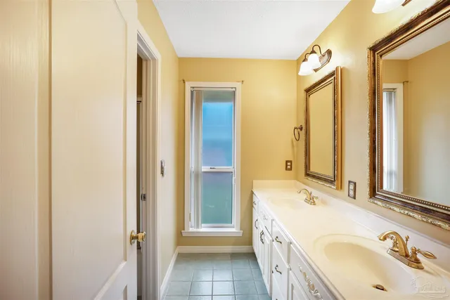 a bathroom with a tub sink and mirror